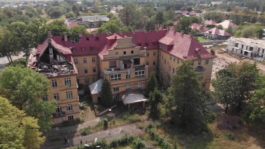 Aerial fast pan around abandoned hospital in Swidnica, Poland, Europe.
