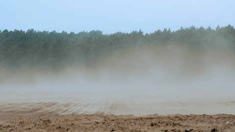 Strong winds sweeping soil off a ploughed field, exemplary for the increase of erosion rates due to unsustainable agricultural practices in Germany.
