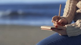 Young girl with notepad on the beach
