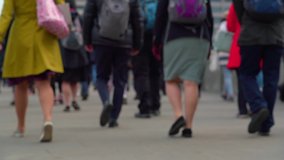Crowd of pedestrian commuters crossing London Bridge on their way to work on cool morning in early May.  Slow motion version – real time version also available. Clip 20a of 66 joins to 20b