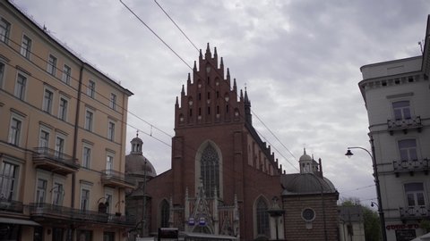 KRAKOW,POLAND- 23 APRIL, 2019: Beautiful Basilica of Holy Trinity and Dominican monastery at Stolarska street in old European town Krakow.Ancient christian catholic temple in Polish historic city