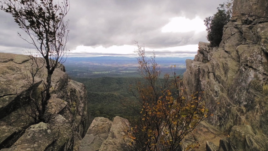 View of the Shenandoah Valley from the top of Humpback Rocks in Virginia just off the Blue Ridge Parkway. Hiking the Appalachian Trail. Fall in Blue Ridge Mountains. Windy overcast day. Slow motion.