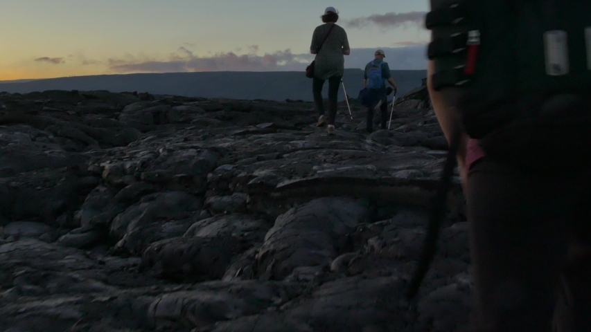 Hikers traverse the vast lava fields found on the big island of Hawaii.