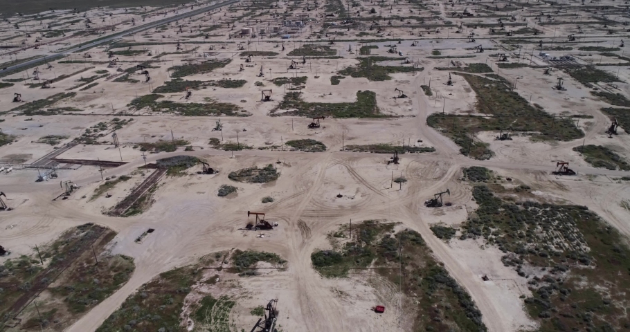 Oil pump oil rig energy industrial machine for petroleum. Field in California, United States. 4k