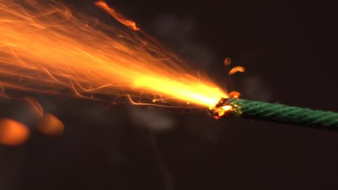 Close up macro shot of Burning fuse firecracker. Setting fire to wick of the bomb dynamite or petard.