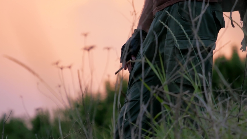 Close-up of cowboy outside with sunset sky at his travel