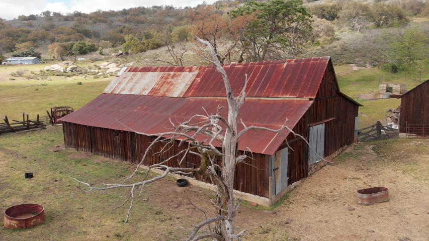 Drone footage flying over a rustic barn in Southern California indian reservation land