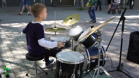 Berdiansk, ZP/Ukraine - 05/08/19:a drummer boy plays on the avenue