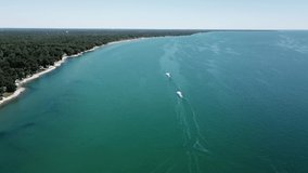 Jet skiing on Lake Huron during the summer in Michigan. Aerial drone footage on a beautiful sunny day.