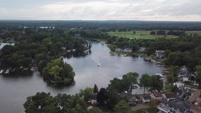 Boating on Lake Orion, Michigan. Aerial drone footage of a sunny summer day. Lots of people and boats out on this populated lake. 