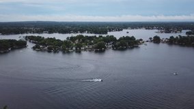 Boating on Lake Orion, Michigan. Aerial drone footage of a sunny summer day. Lots of people and boats out on this populated lake. 