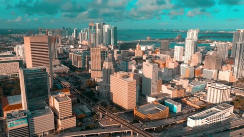MIAMI, FLORIDA, USA - MAY 2019: Aerial drone view flight over Miami downtown. Streets, hotels, residential and business buildings from above at sunny day with clouds.