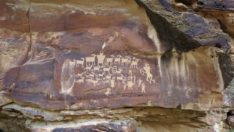 View of petroglyphs carved into the cliffs in Utah rotating around The Great Hunt Panel in Nine Mile Canyon.