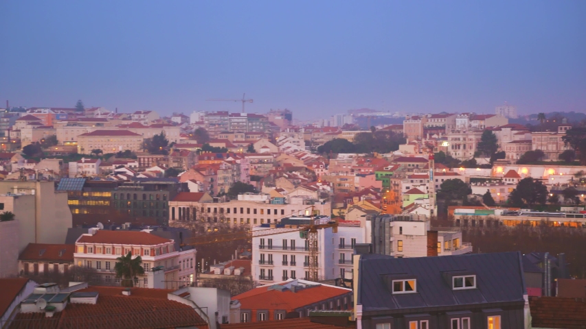 Panoramic rooftop view of Lisbon old town city center from the viewpoint of Principe real (Royal Prince) at dusk, and a bit of sunset, Portugal.