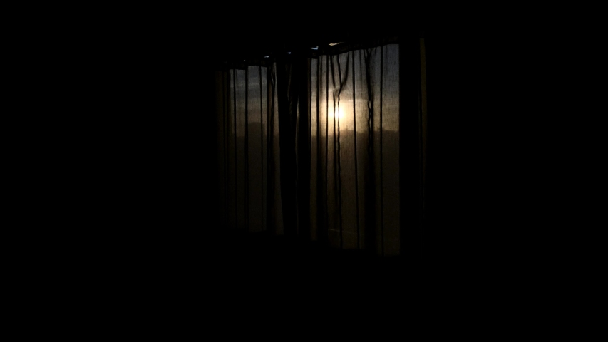 Young girl wakes up and opens shades and streches in beautiful morning sunlight. 
Sunlight shines through window and dark room as girl opens shades, | Shutterstock HD Video #1029571952