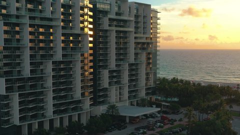 MIAMI, FLORIDA, USA - JANUARY 2019: Aerial drone panorama view flight over Miami beach city centre at sunrise. Streets, hotels, shopping malls and residential buildings from above.