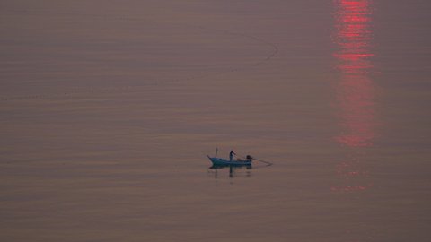 The small fishing boats in the wide sea on morning sunset 