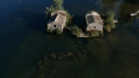 Birds-eye Aerial shot Flying over old the water mill river lanscape