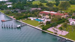 MIAMI, FLORIDA, USA - MAY 2019: Aerial drone view flight over Miami Biscayne Bay and Indian Creek island. Luxury houses, boats and yachts from above.