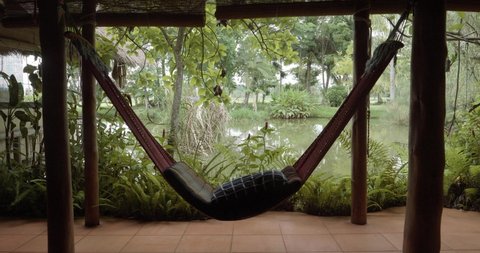 Hammock in Front of Pond in Traditional Thai House