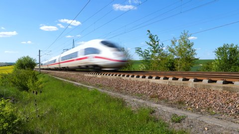 Dauborn, Germany - May 15, 2019: Tracking shot of a passing ICE train on the highspeed line Frankfurt - Cologne near Limburg. ICE is a highspeed train system in Germany