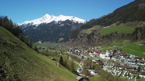 Austrian Alps Landscape in Stubai Valley, Neustift Town, with green grass around and snowcovered Mountains in the Background