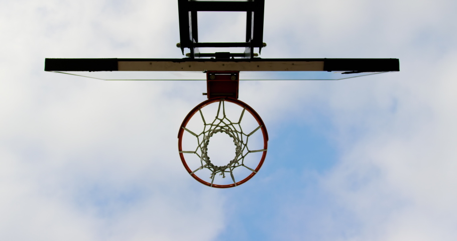 Upward view of multi-ethnic basketball players playing basketball in basketball court. They are making a goal 4k Royalty-Free Stock Footage #1029607787
