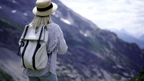 Excited caucasian female tourist in casual outfit shooting panoramic video on smartphone camera of scenery nature in mountains, happy woman travel blogger making picture of breathtaking Alps landscape