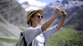 Caucasian hipster girl wanderlust using cellphone for making photo during summer journey close to nature, 360 view, female tourist shooting video on mobile phone camera while discovering National Park