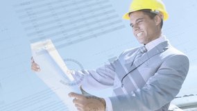 Digital composite of a Caucasian engineer in a suit and hard hat while looking at a plan with background of graphs moving - Powered by Shutterstock - Get 15% off with code: PIKWIZARD15