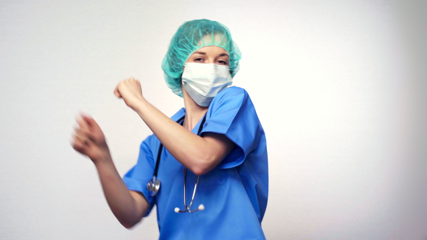 Portrait of funny female doctor which dancing on a white background. doctor dancing. Concept: profession, medecine, medical education.