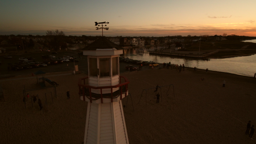Lighthouse with sunset on beach, beautiful summer evening