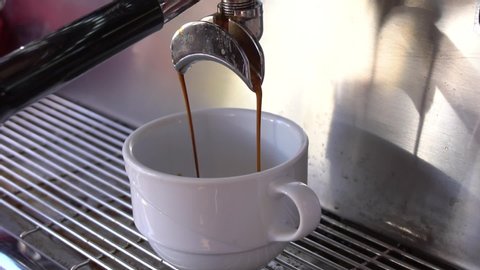 Cup Of Coffee Being Poured From A Professional Espresso Machine.