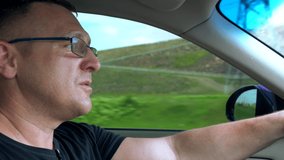 Man driving through mountainous terrain
