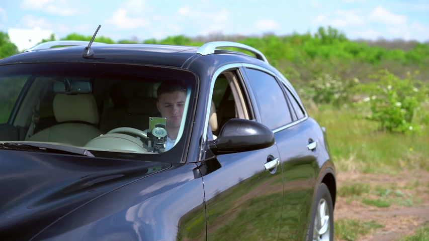Man opening the door of a car and getting out