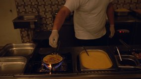 Chef cooking a fresh egg omelette