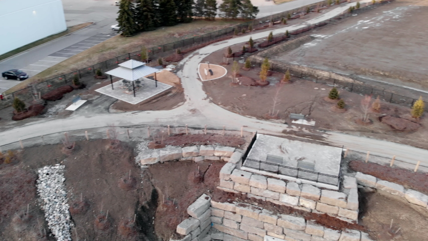Birds eye view of a park in the middle of the city. Featuring water and trees.
