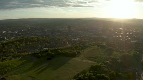 Aerial footage of Sheffield City and surrounding suburbs at sunset in Spring. Sheffield is one of England's greenest cities, surrounded by grassland and the Peak District National Park. 