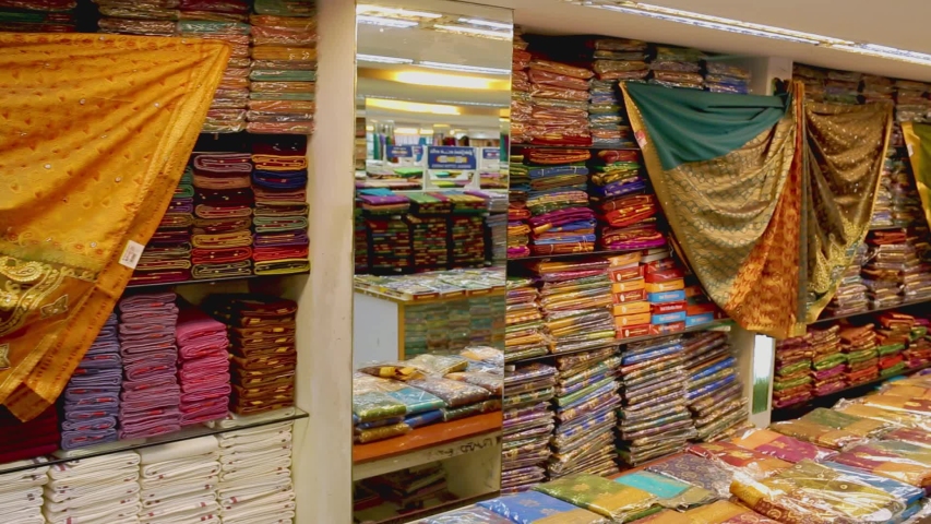 Shop of women's clothing. Sari Shop. Indian Traditional Women's Sari clothing on Market. Buying Wedding Sari in India. Lot of Colorful Beautiful Sari Dresses in the Store., a Business & Finance Video by ashok india
