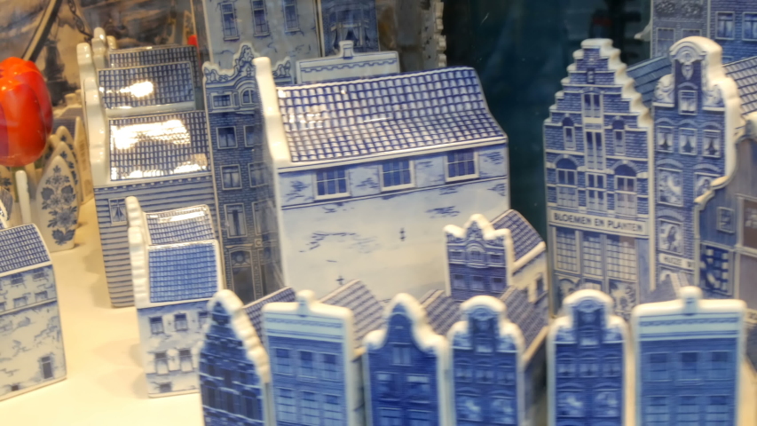 Porcelain blue rolling houses and red tulips in the Dutch style, in a shop window in Amsterdam, the Netherlands