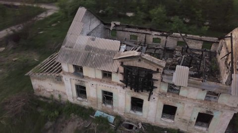 Aerial view. Old ruined building. Abandoned house. Dismantling the building structure. Demolition of the ruins on the outskirts of the city