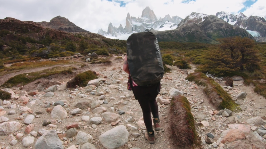 Woman Traveler with Backpack hiking in the Mountain leading to the Mount Fitz Roy, Patagonia, Argentina. 4k