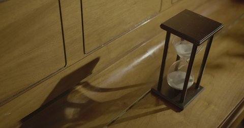 time-lapse of hourglass, showing the shadowsing.