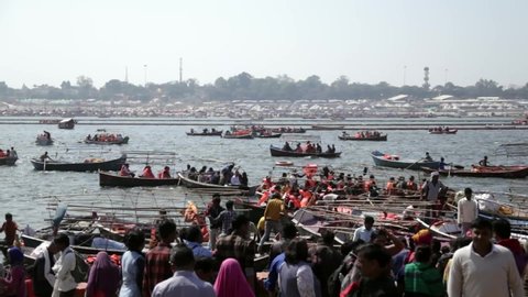 Allahabad, Uttar Pradesh / India - February 23, 2019: People are waiting for boat-ride near holy river "The Ganges"  during Ardh Kumbh Mela.