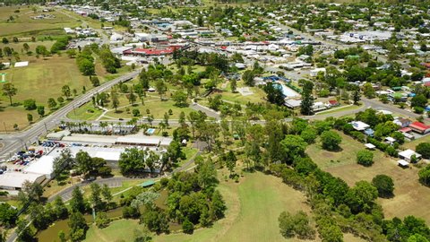 Rising aerial shot of the town of Beaudesert in the Scenic Rim region of Queensland Australia. Drone reveals entire town at midday on a stunning blue day.