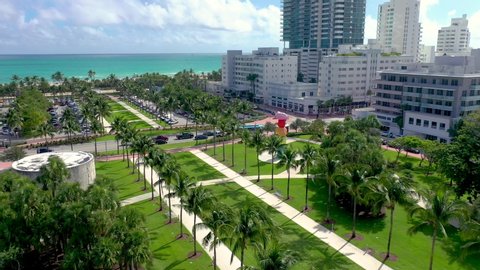 MIAMI, FLORIDA, USA - MAY 2019: Aerial drone panorama view flight over Miami beach city centre. Collins park from above at sunny day. Streets, hotels, residential buildings around.