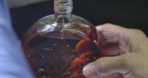 Natural Maple Syrup Filling up a Bottle