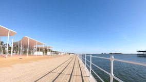 Walking at seafront promenade of Huelva on sunny day, Andalusia, Spainy - Powered by Shutterstock - Get 15% off with code: PIKWIZARD15