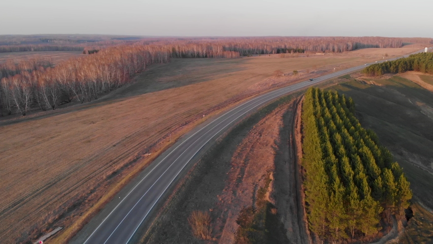 Aerial view of a road in summer landscape, cinematic drone footage