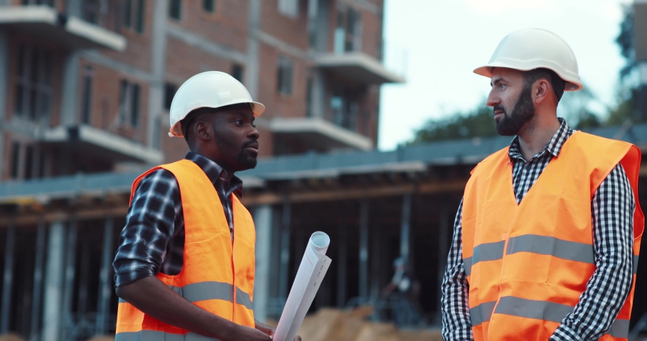 Handsome young Afro-American architect discusses a project with a professional vendor. Profession concept, being busy, doing business. Male portrait